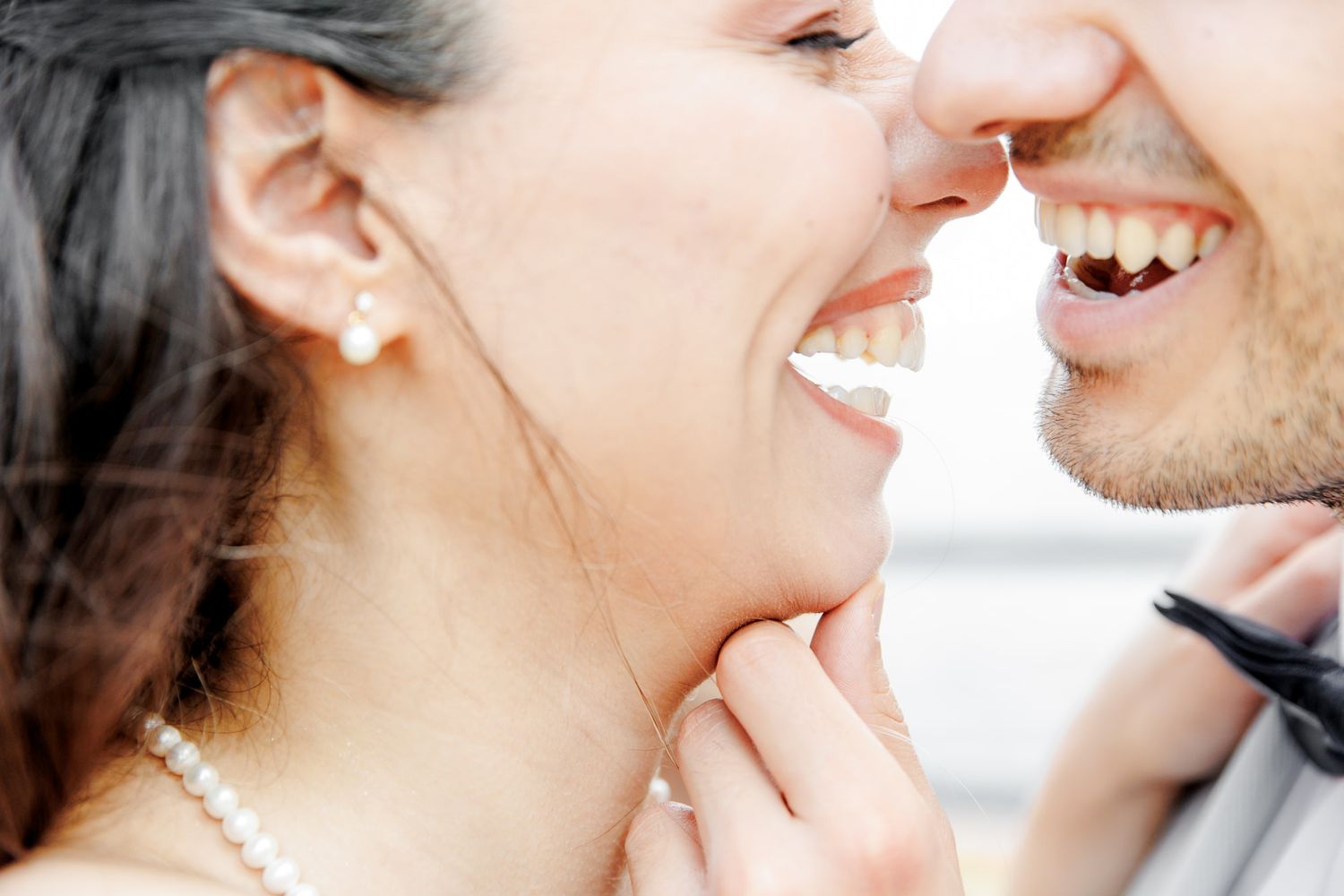 A candid moment of the couple laughing after the kiss