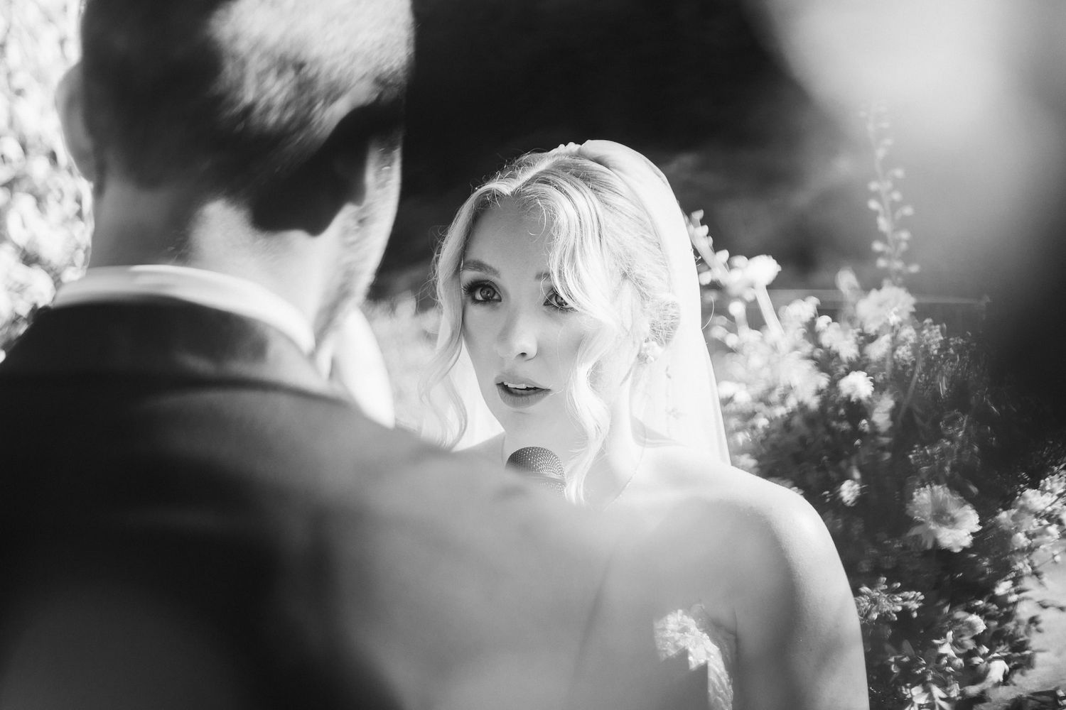 A romantic black and white wedding photo showing intimate moments between a couple during their celebration.