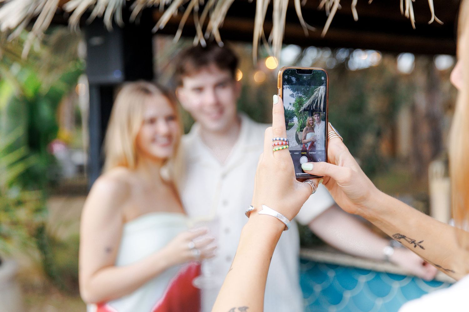 Candid moment of friends reuniting at a destination wedding rehearsal party in Spain