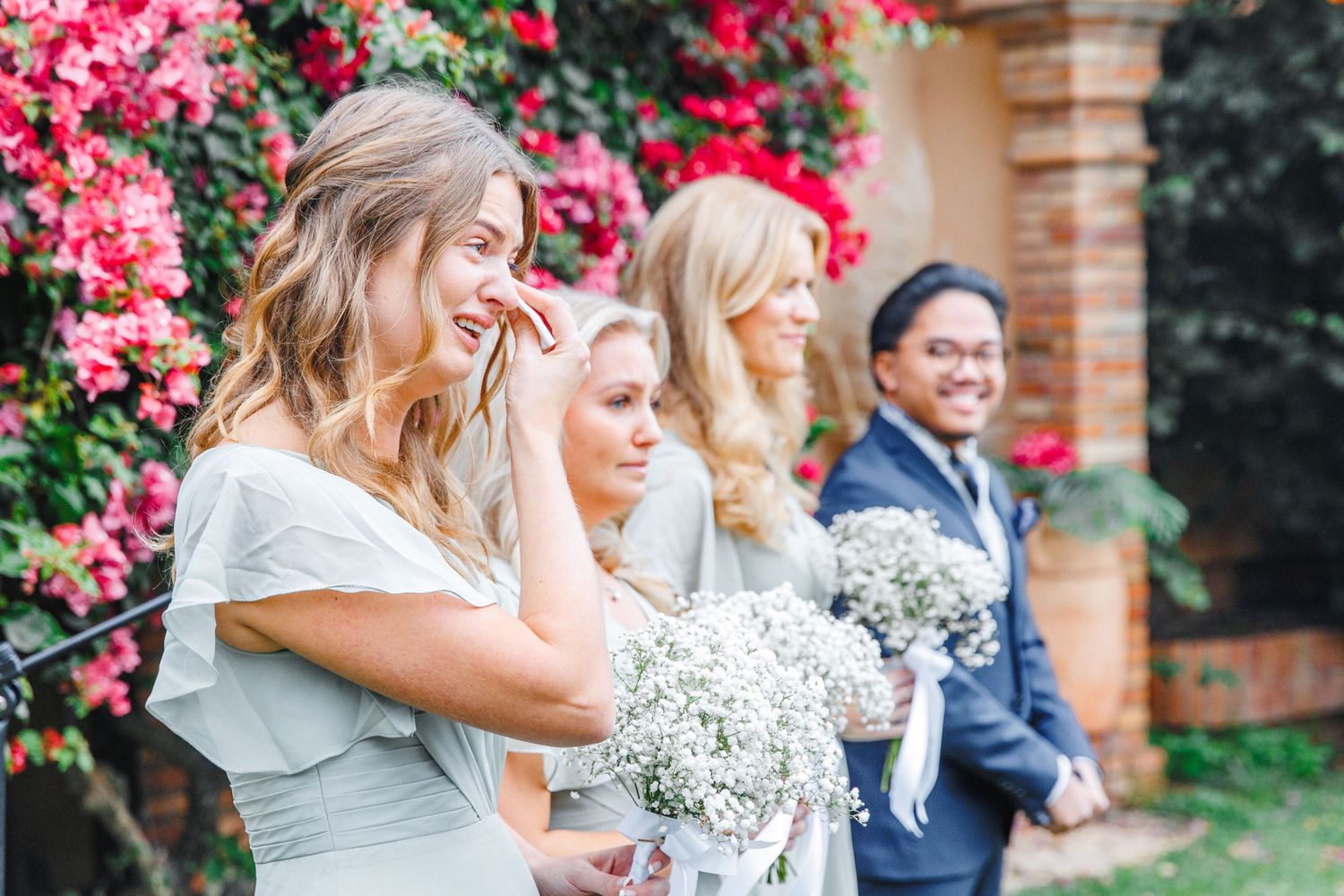 An emotional candid moment of bridesmaids crying over the wedding ceremony in Barcelona