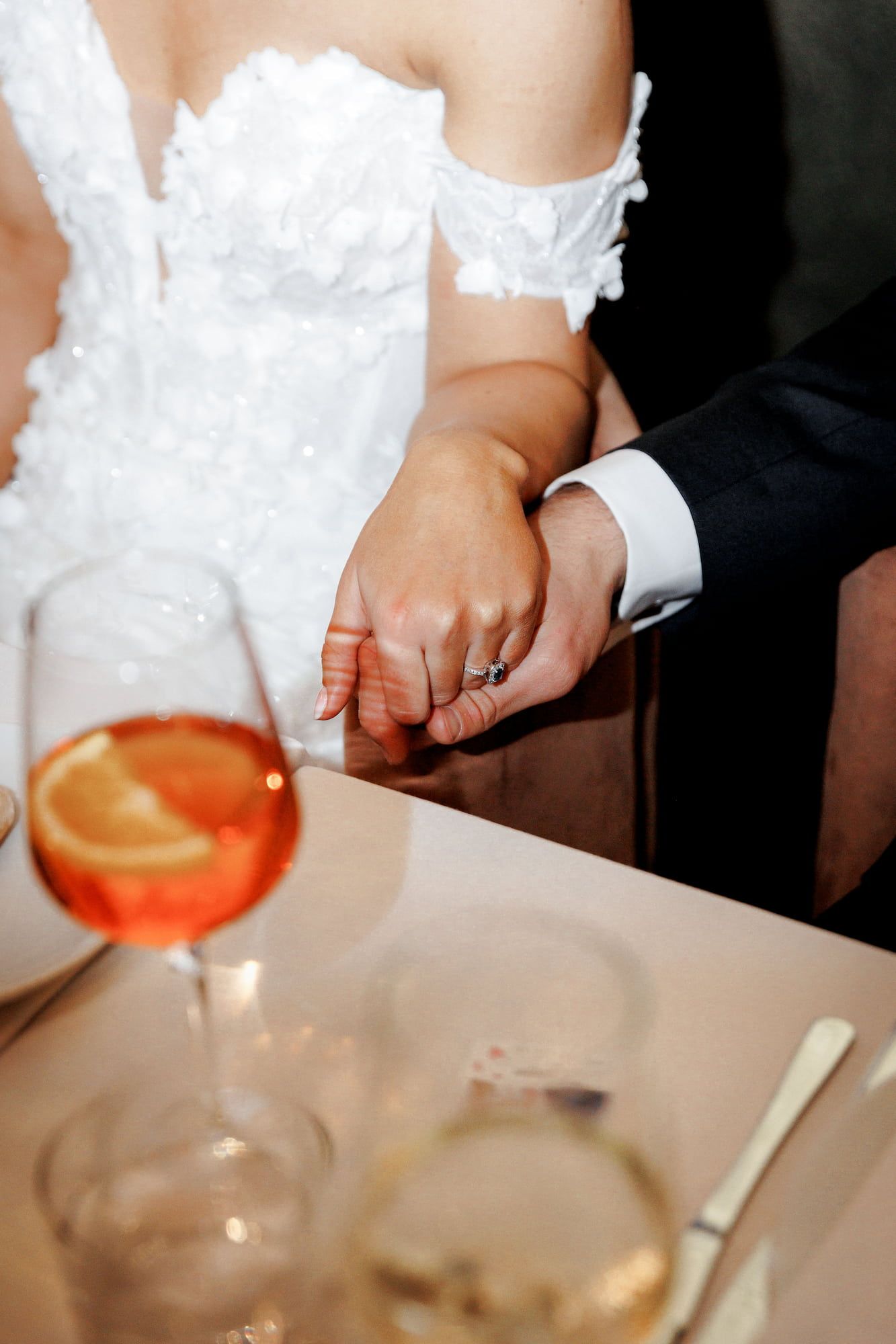 Bride and groom holding hands at wedding reception in Gran Villa Rosa