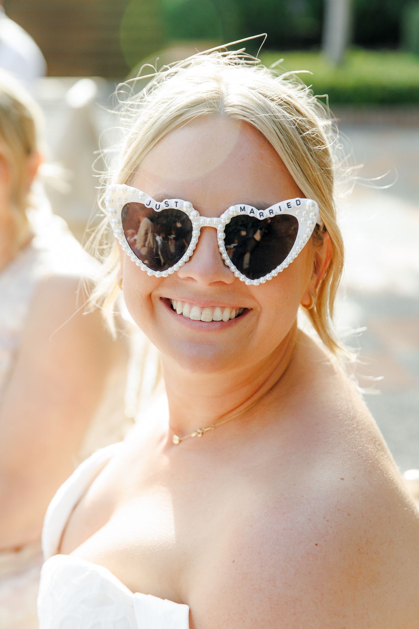 Smiling bride wearing white heart-shaped 