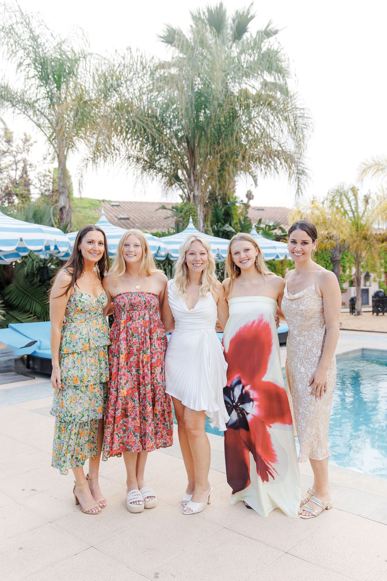 Warm candid portraits of wedding guests at a rehearsal party in Spain