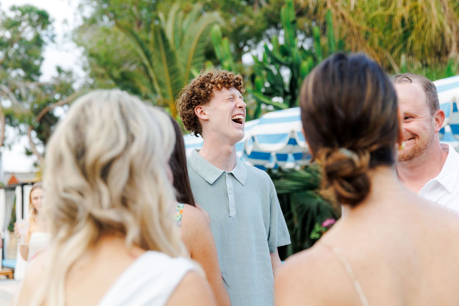 Guests sharing a laugh with friends at the rehearsal dinner in Spain
