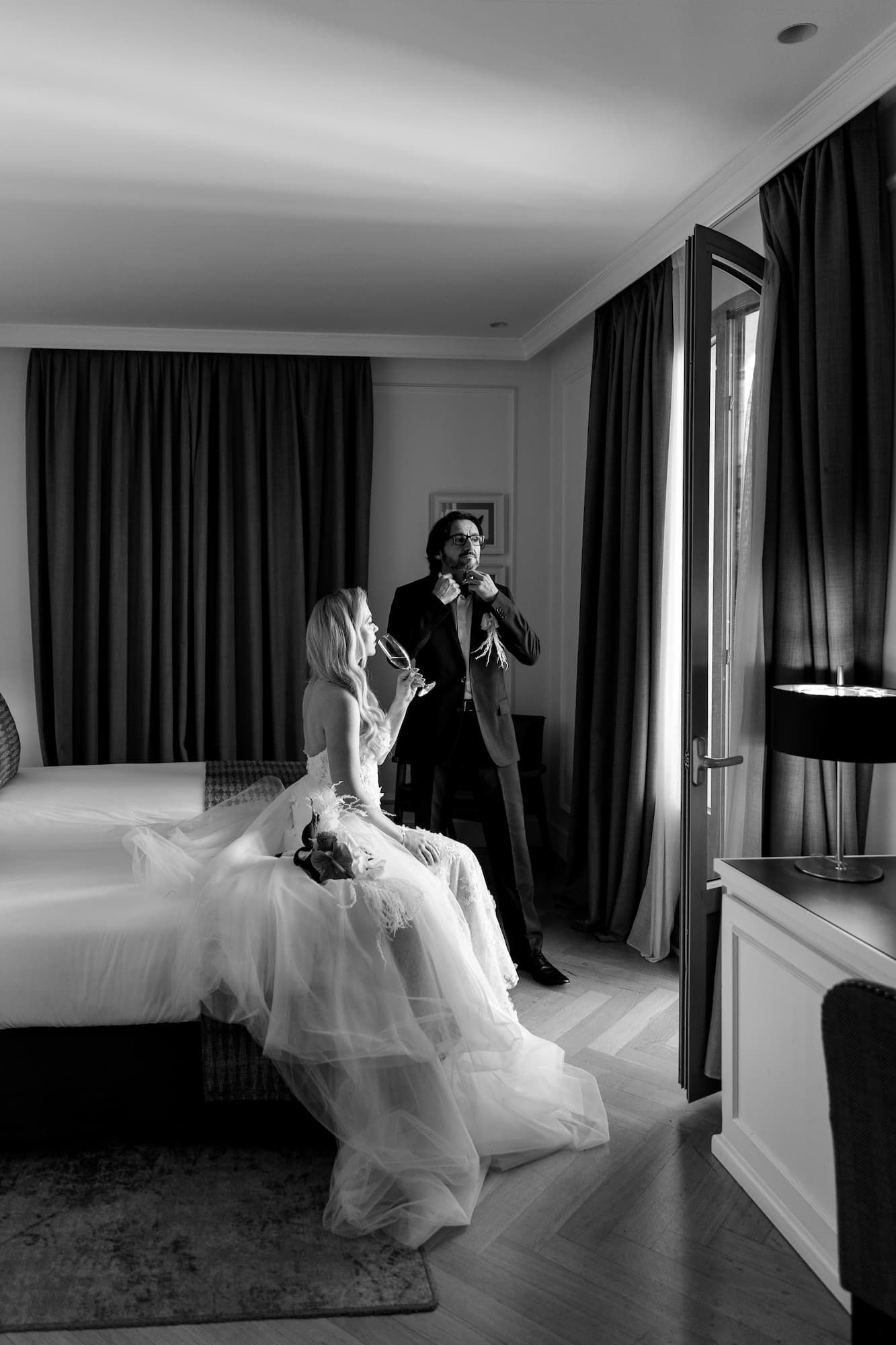The wedding couple poses for artistic black-and-white portraits at an elegant hotel in Barcelona.