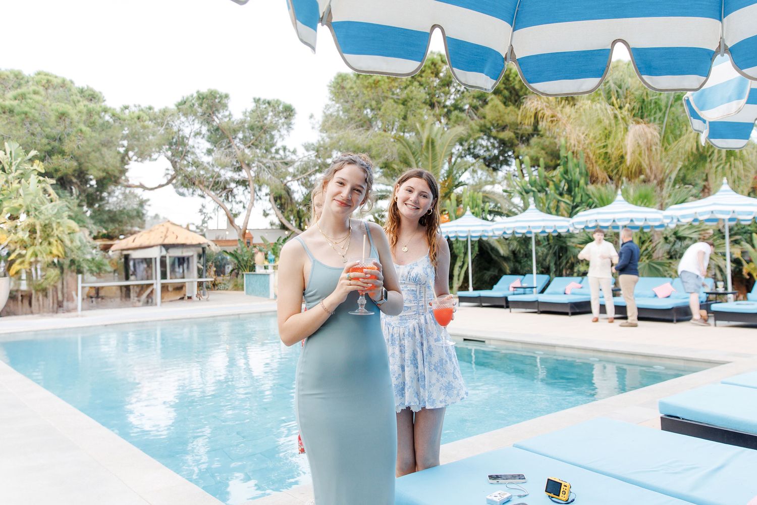 Guests are posing to a wedding photographer who captures the rehearsal dinner in Barcelona