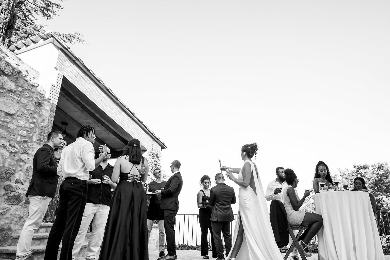 Black and white photo series showing candid moments from an elegant outdoor wedding celebration.