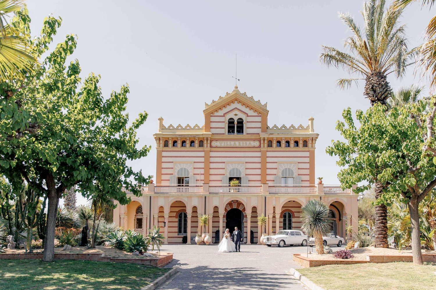 Gran Villa Rosa facade, ideal venue for destination weddings, captured beautifully with the groom and bride dancing in front of the villa.