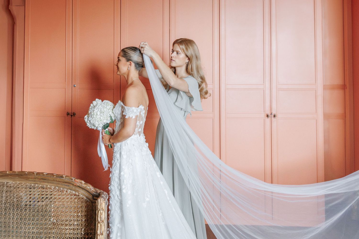 The maid of honor adjusts the veil before the bride heads down the aisle at Barcelona wedding