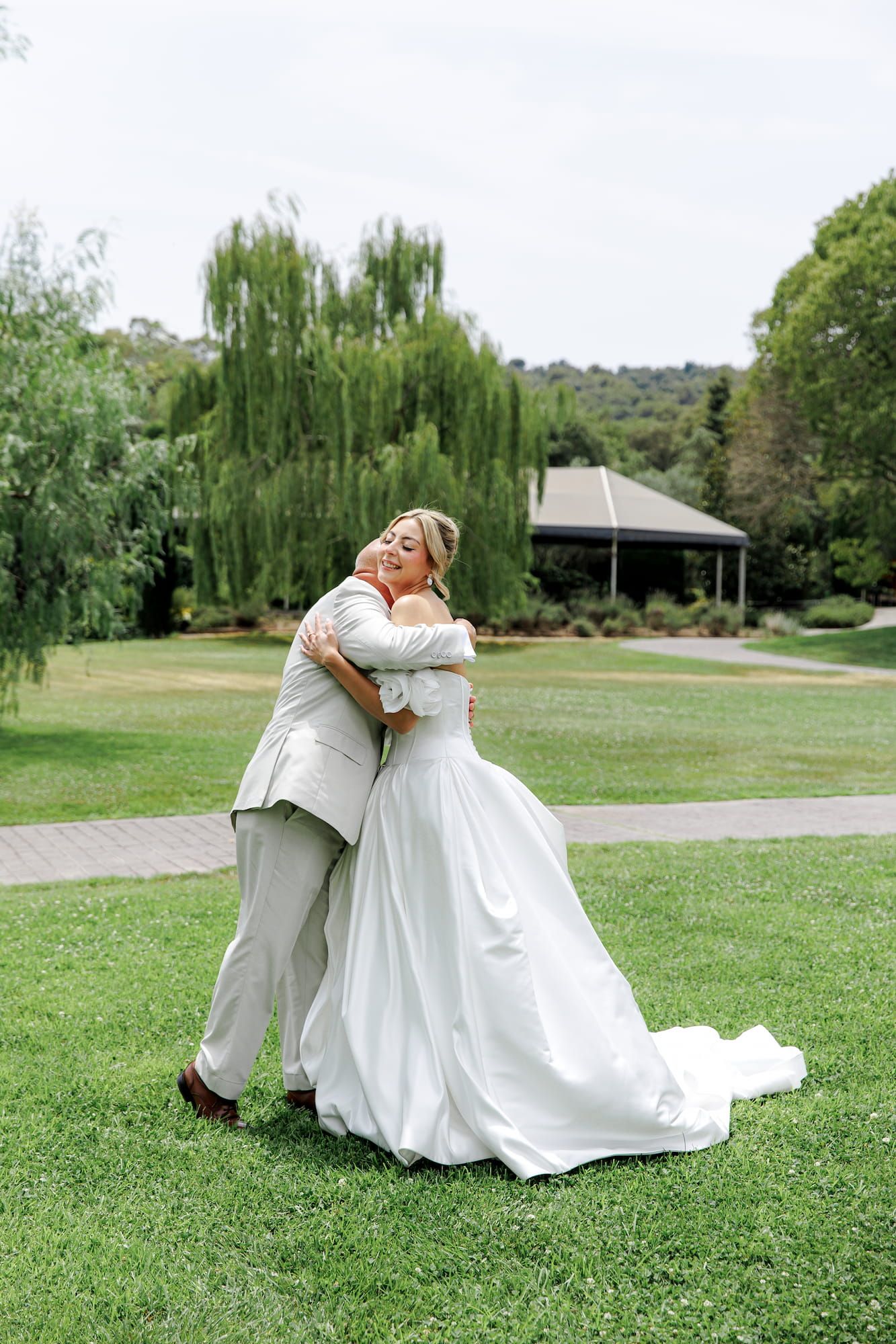 A bride in a white gown meets her father for the first time before the wedding ceremony in Barcelona.