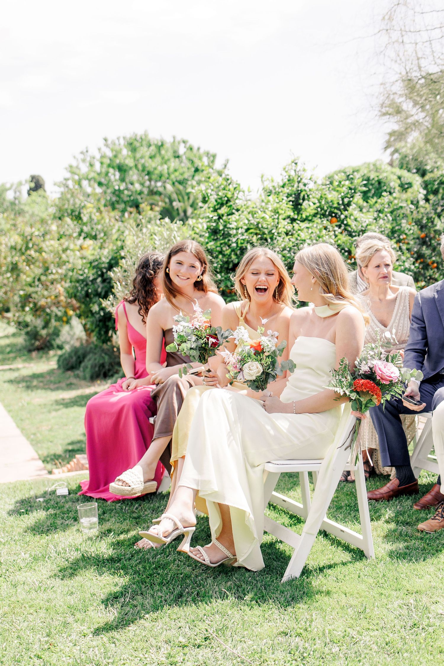 Emotional shot of the guests laughing during the summer wedding ceremony in Barcelona.