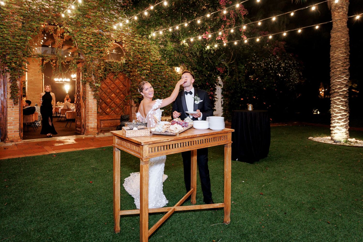 Bride and groom, during the cake-cutting ceremony at a Barcelona wedding, share in the joy