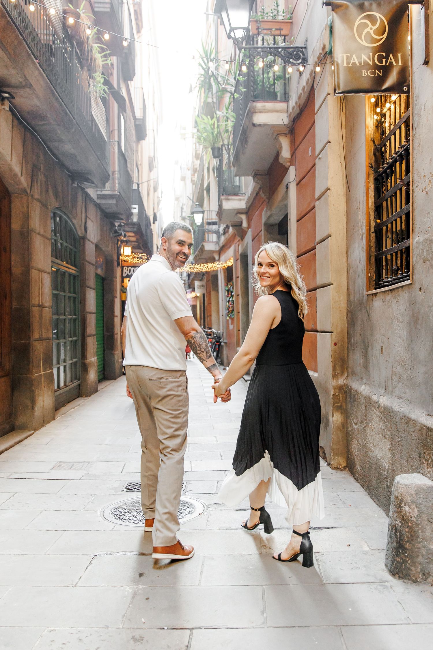 A couple enjoys a romantic walk in the historical area of Barcelona