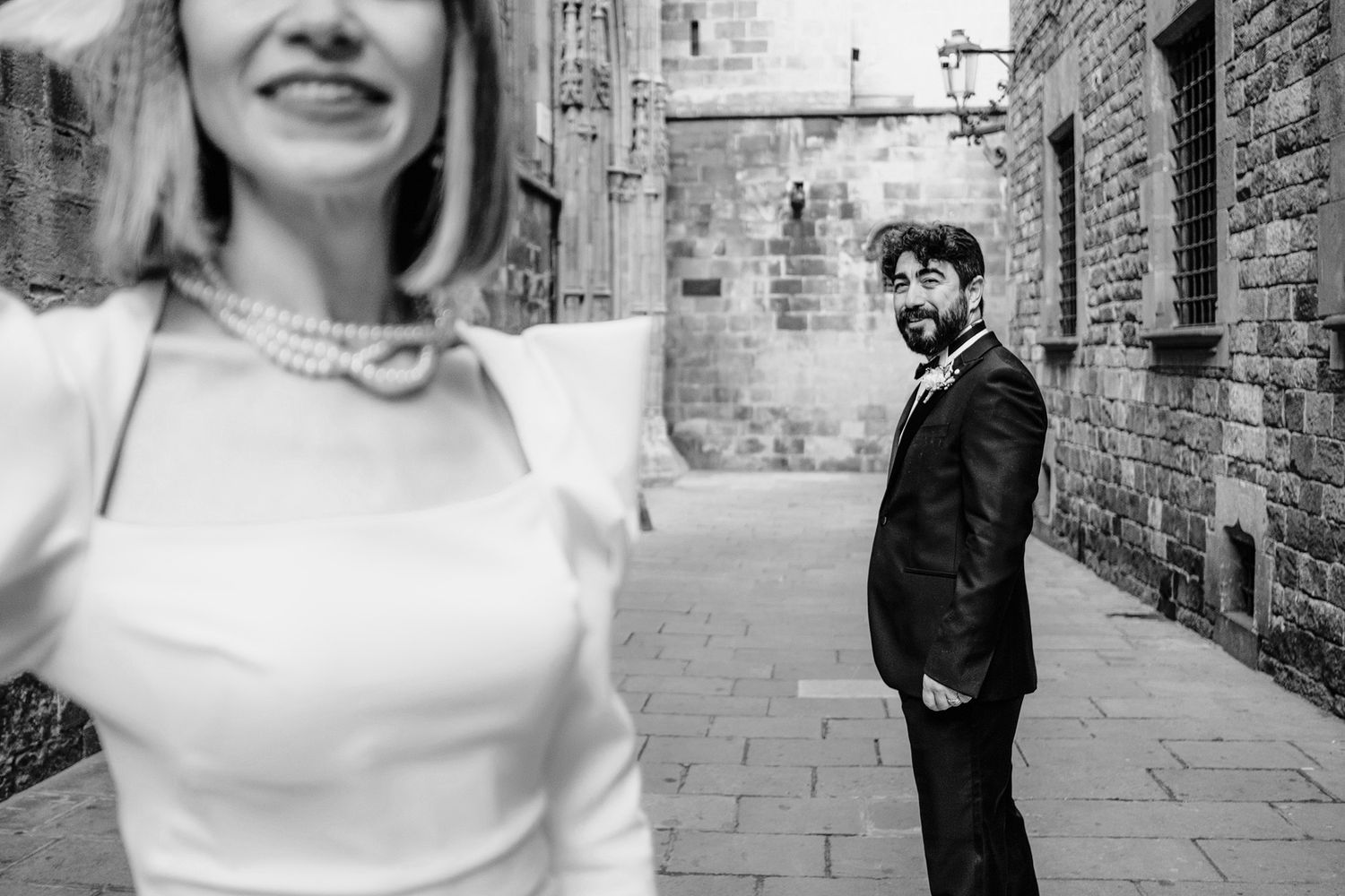 A newly married couple walks through the streets of Barcelona's historic city center.