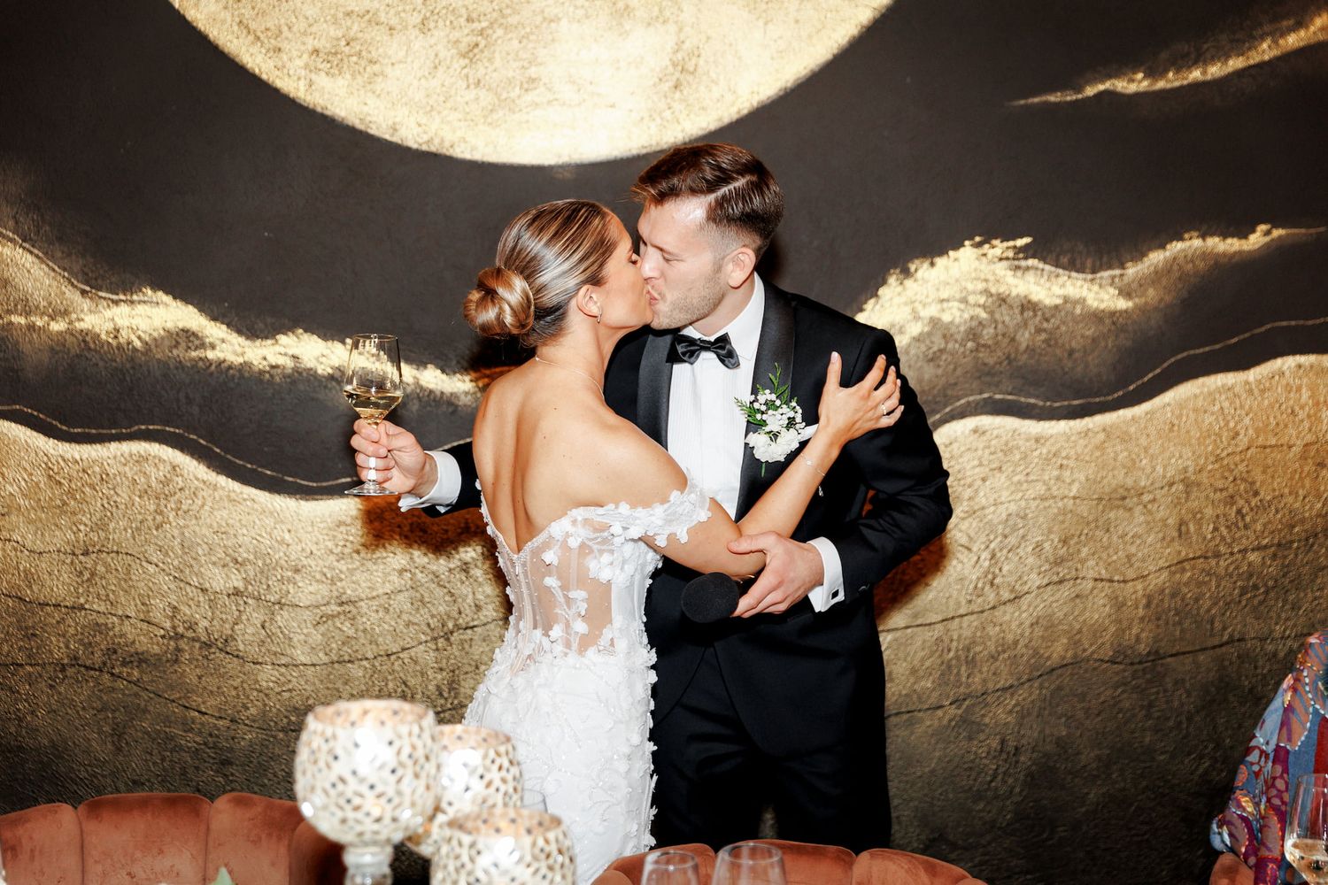 The bride gives a kiss to the groom after giving a speech at their wedding in Gran Villa Rosa