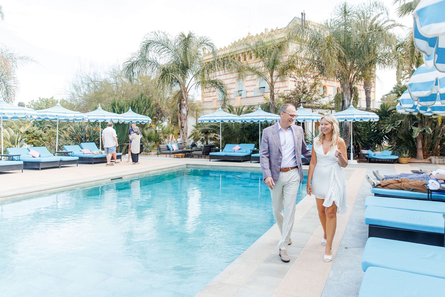 The couple walking happily in anticipation of the summer rehearsal dinner at the destination wedding Gran Villa Rosa