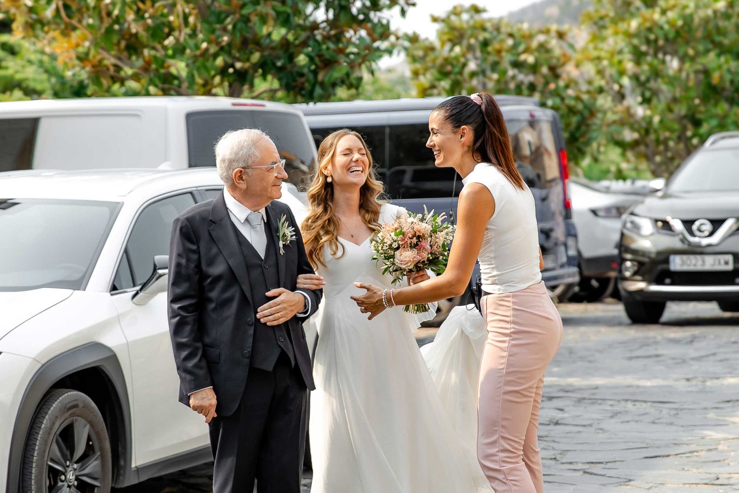 A wedding planner comforts the bride before she enters the church for the ceremony.