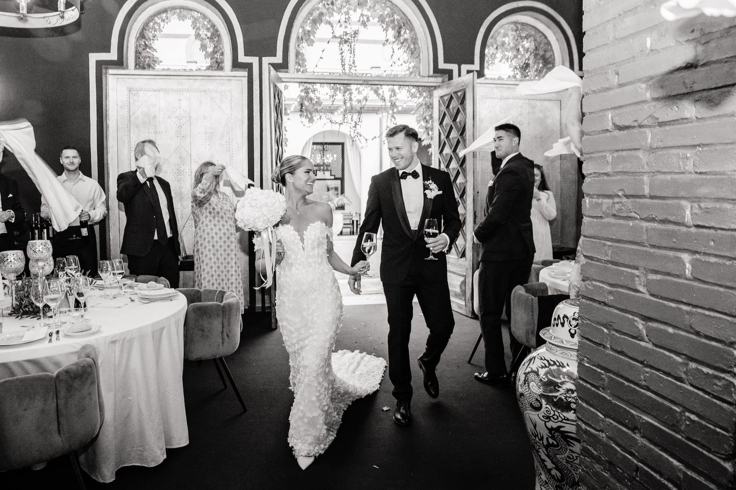 Black and white photo of a bride and groom making a grand entrance Aat Gran Villa Rosa, Barcelona Wedding Venue