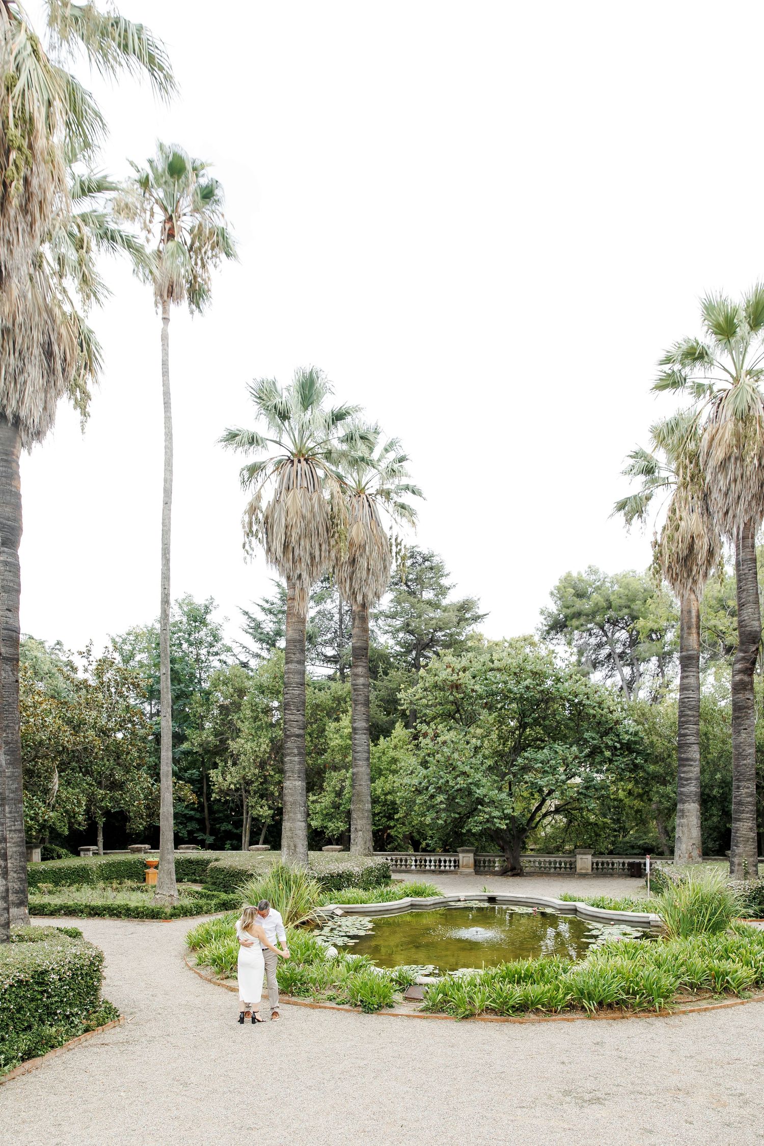 A couple walks among beautiful gardens in Barcelona