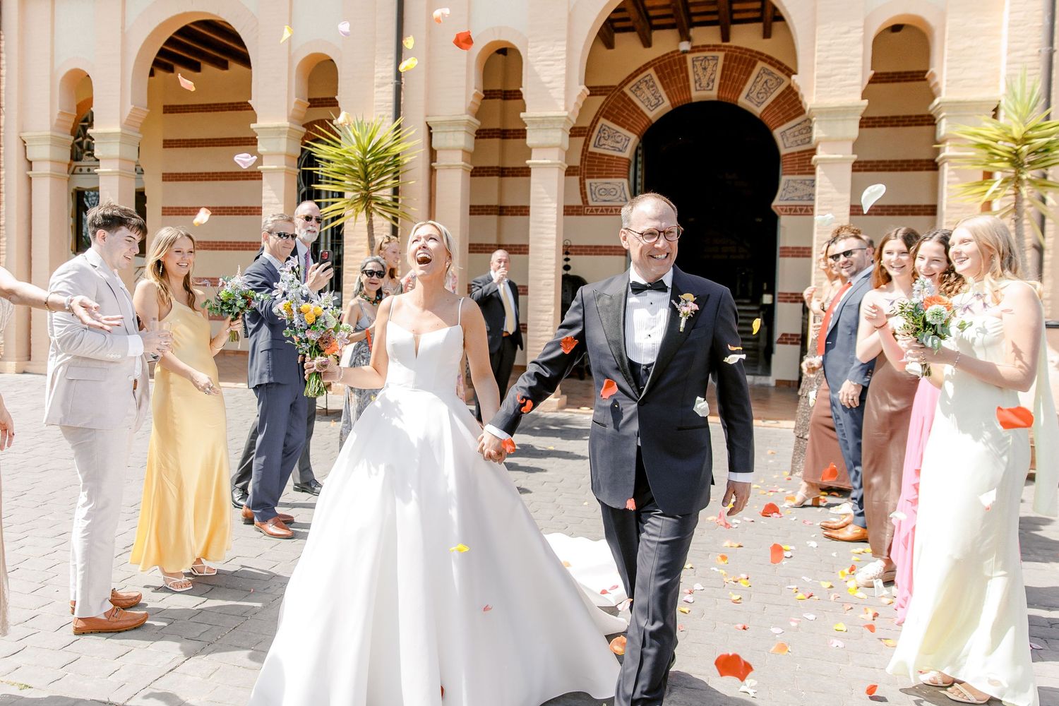 The groom and the bride walking down the aisle after the wedding ceremony at Gran Villa Rosa.