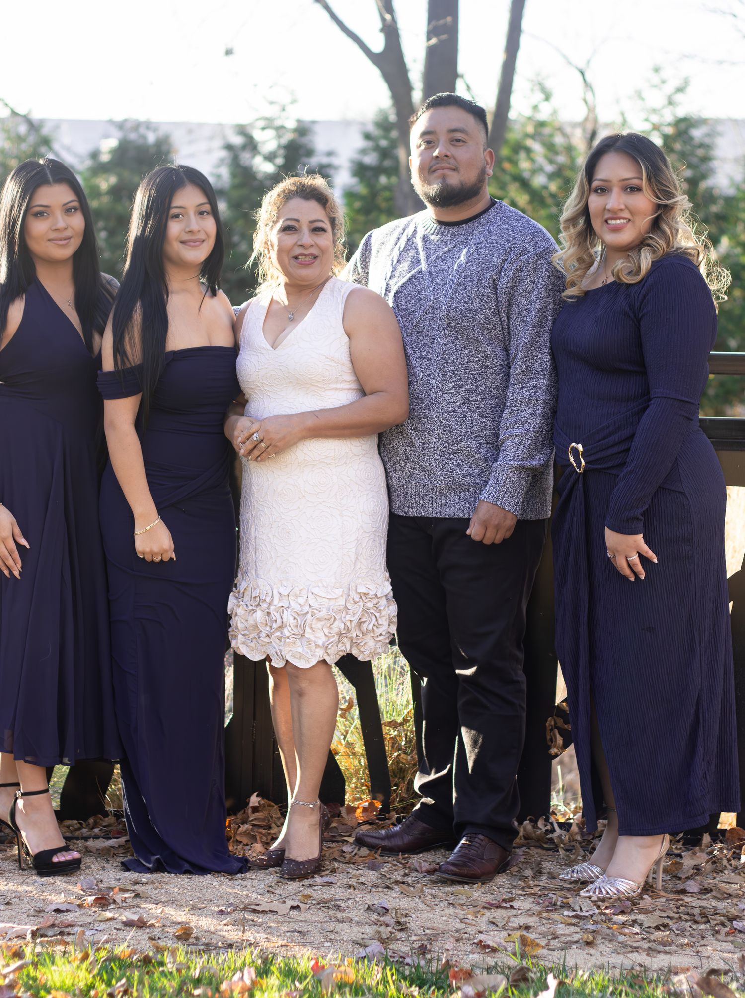 Family group photo with everyone wearing coordinated navy blue and white outfits.