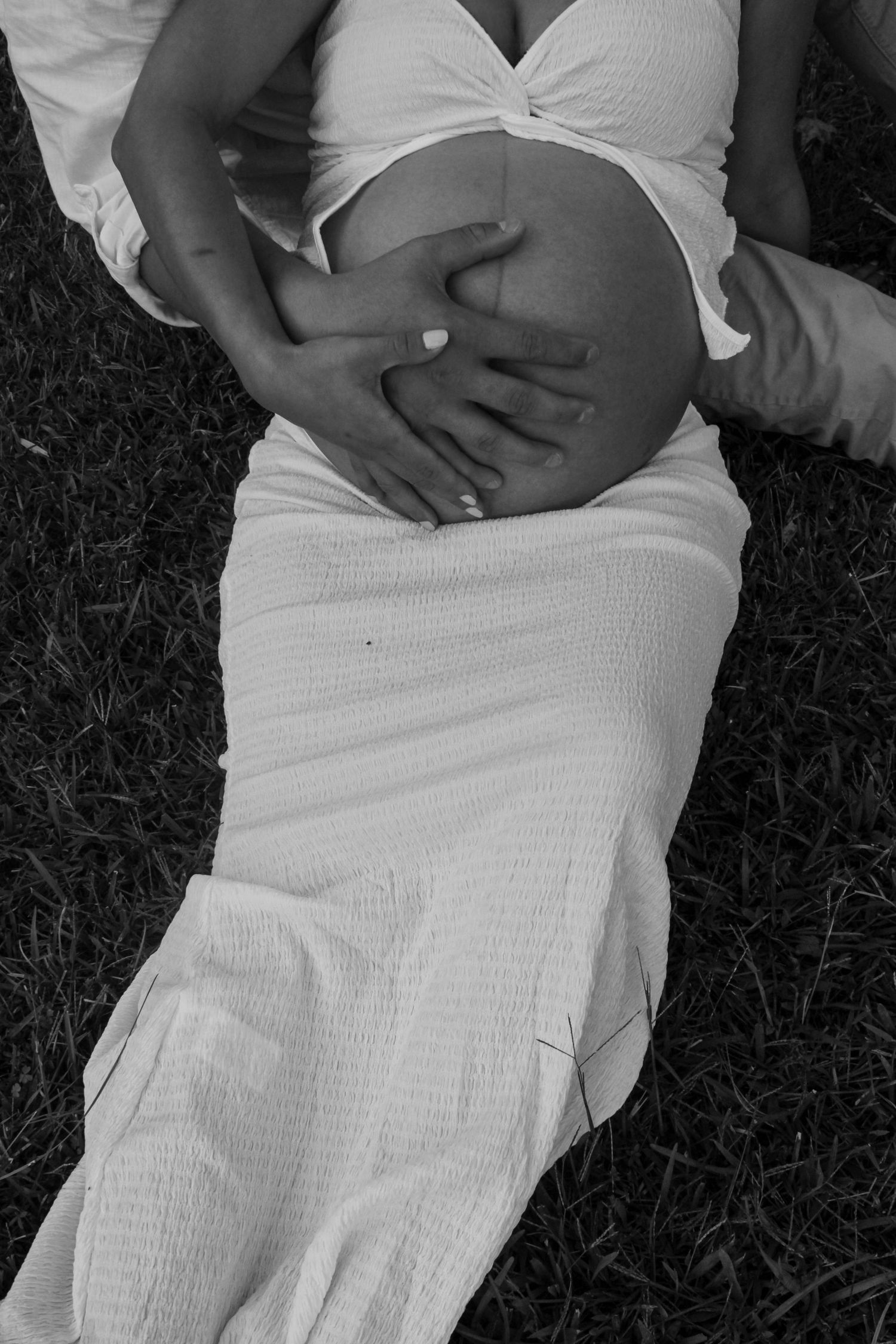 Black and white maternity photos showing close-up shots of a pregnant belly.