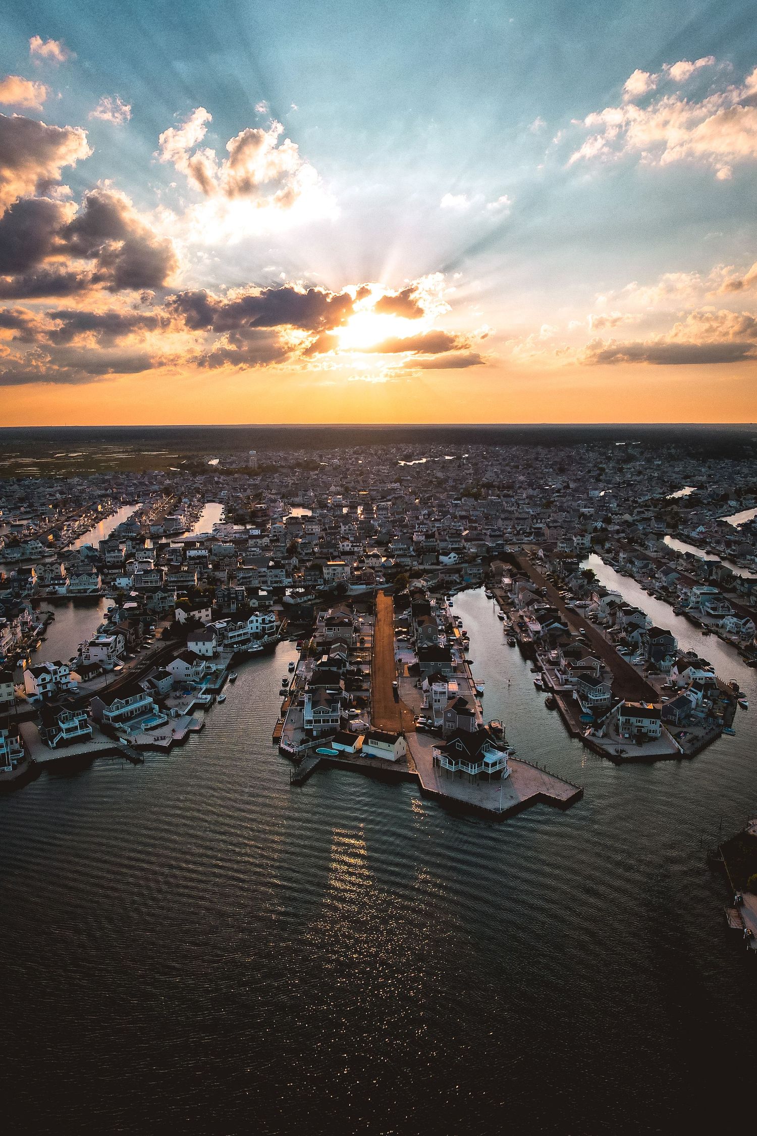 Aerial view of harbor marina at sunset with dramatic clouds, fine art landscape photography print