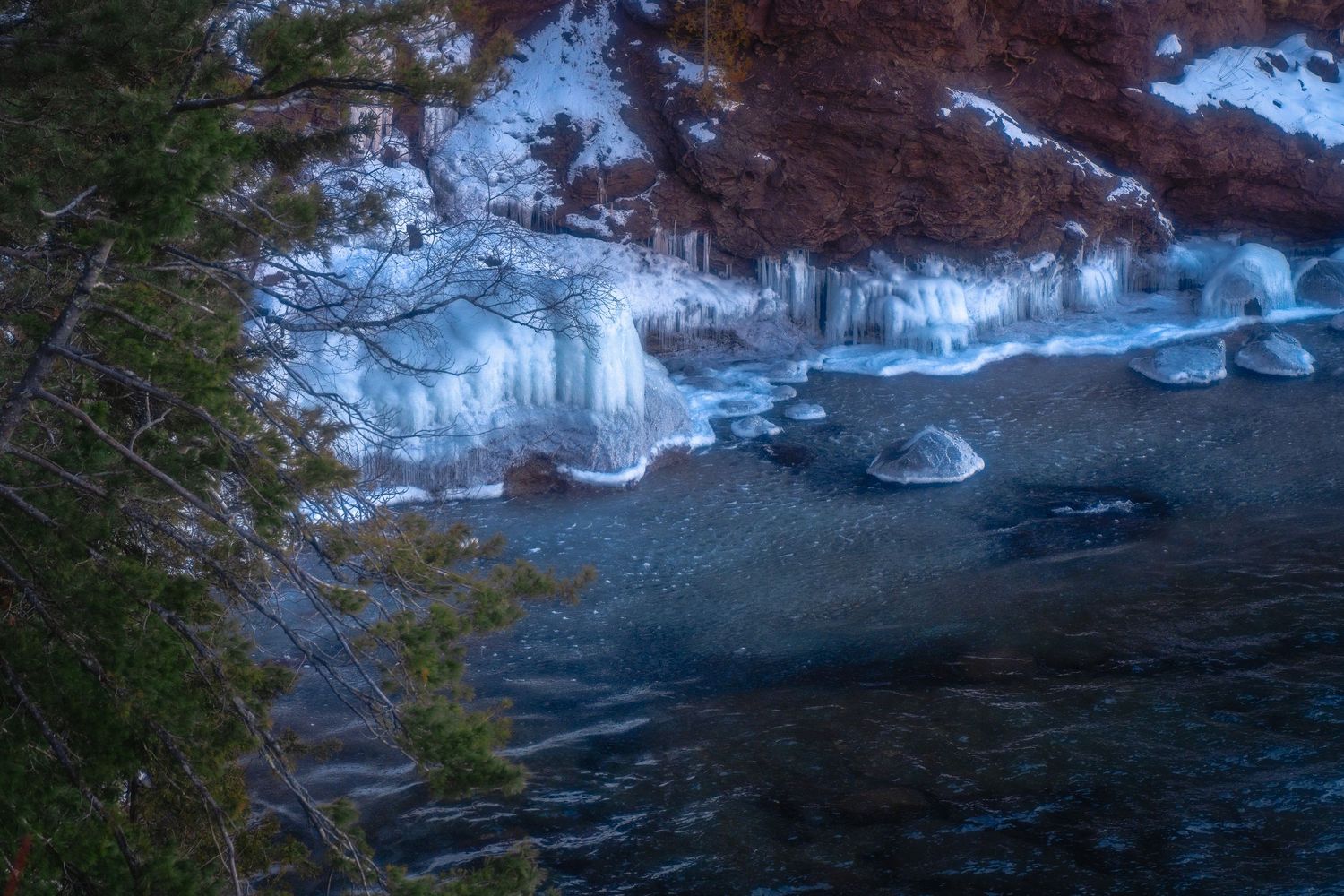 Frozen waterfall with blue-white ice formations in winter, fine art nature photography print