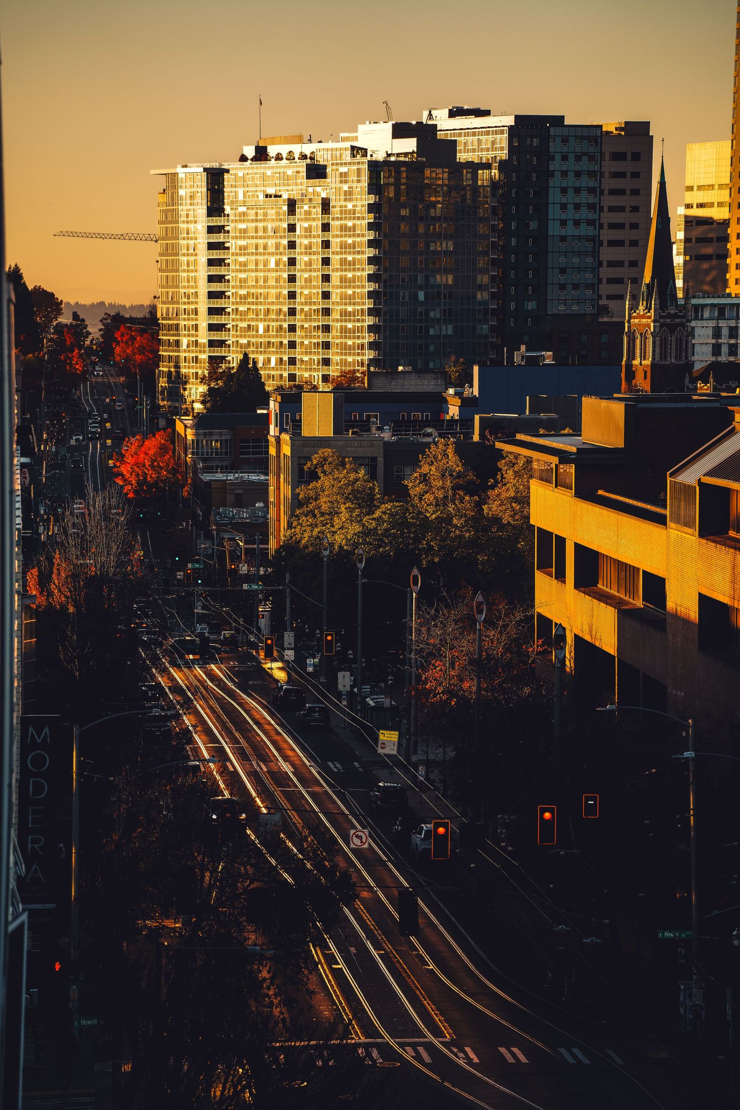 City skyline towers at dusk with warm golden light, fine art urban photography print