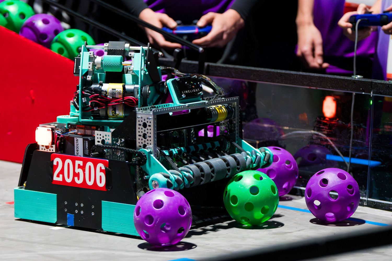 VEX robotics competition robot number 20506 with colorful balls on playing field.