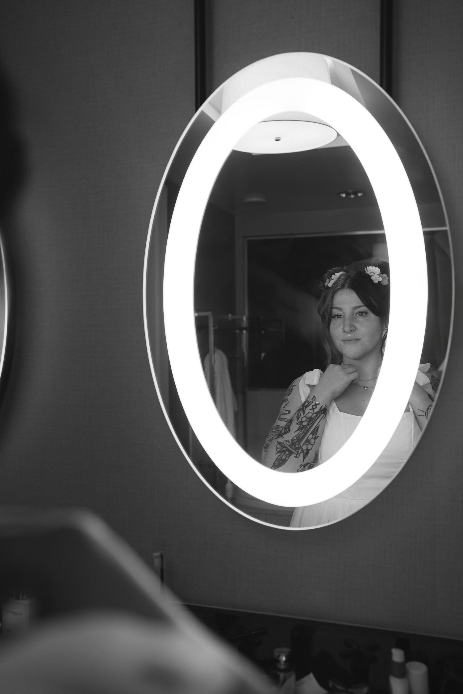 A black and white photo of a reflection in an illuminated circular mirror.