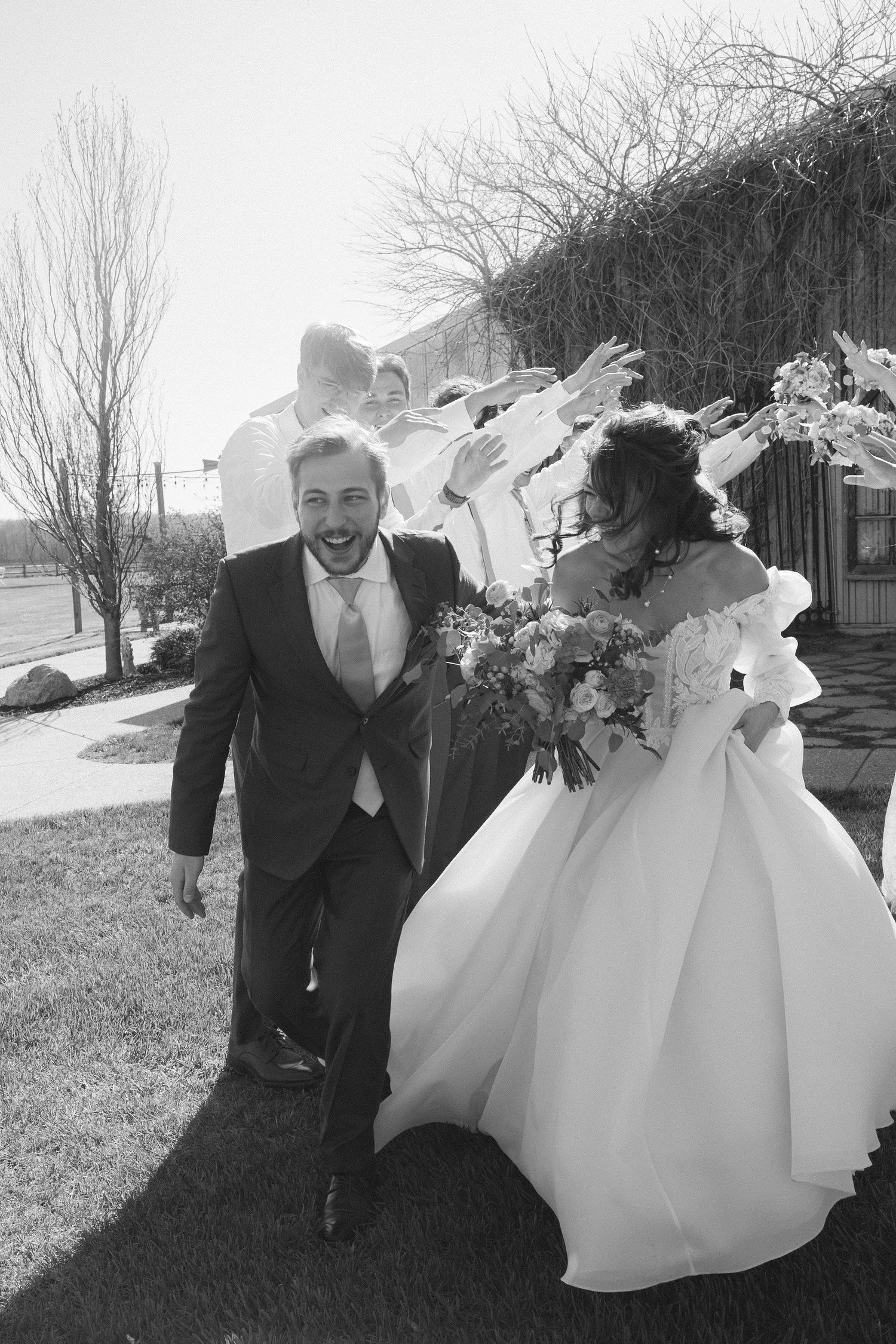 A playful wedding photoshoot in winter shows the couple dancing and twirling in the snow.