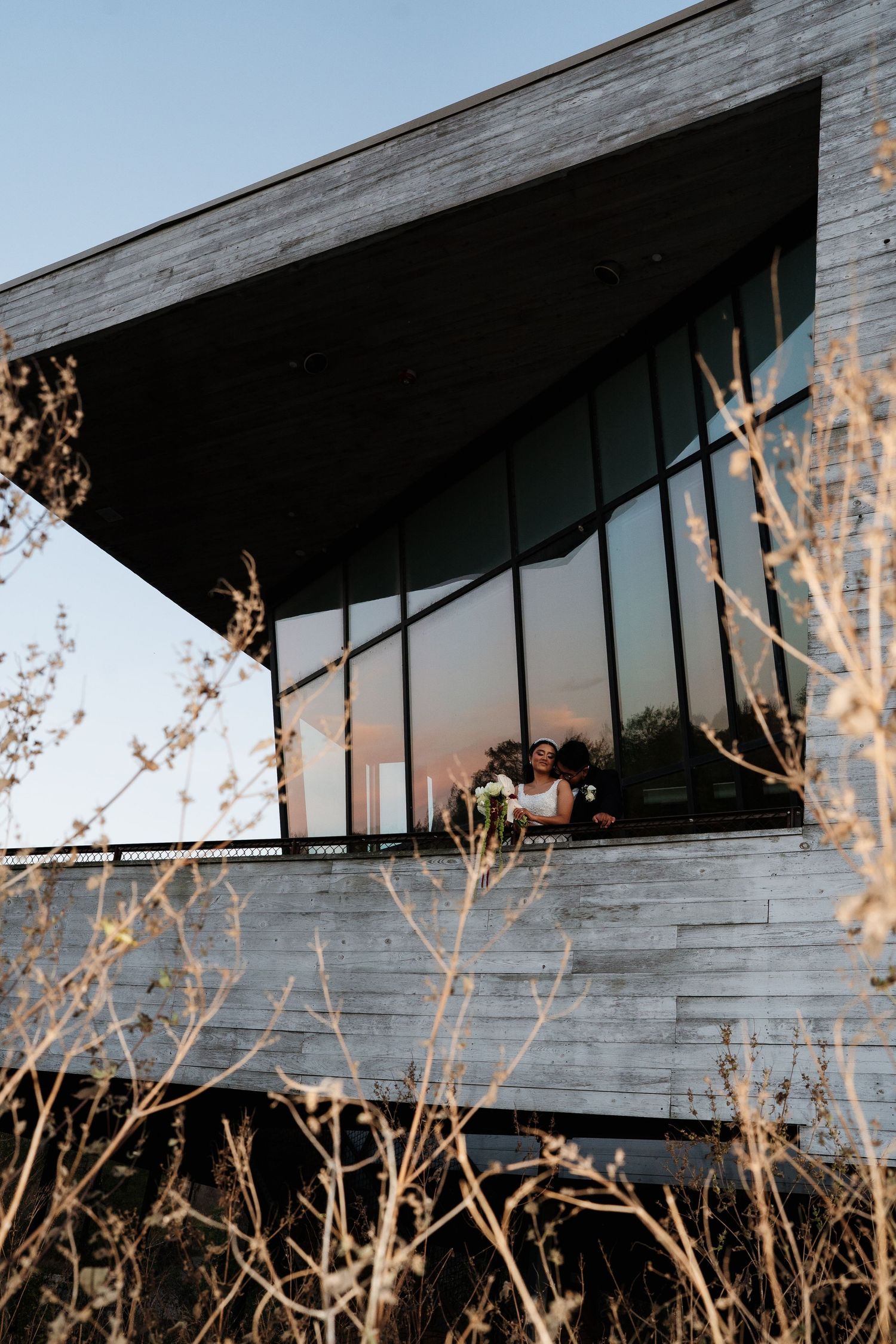 Modern architectural structure with angular lines photographed against winter foliage.