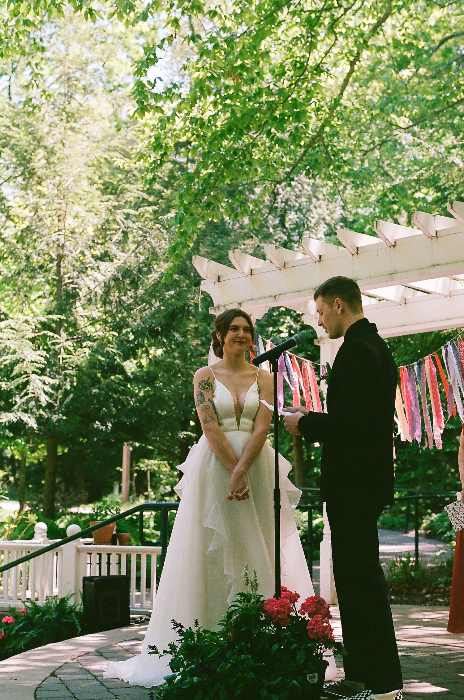 Wedding ceremony on decorated porch with string lights and bunting.