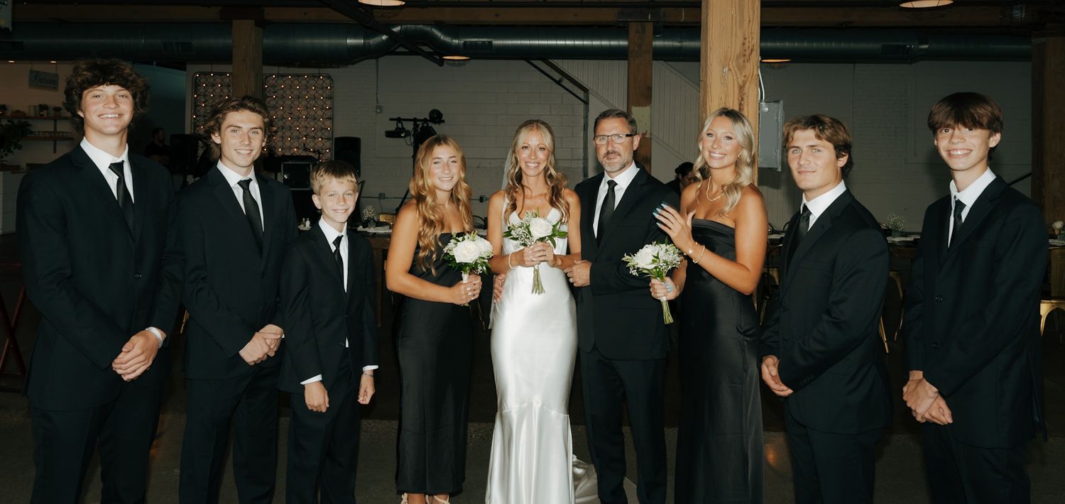 Wedding party members gathered in formal attire for group photos.