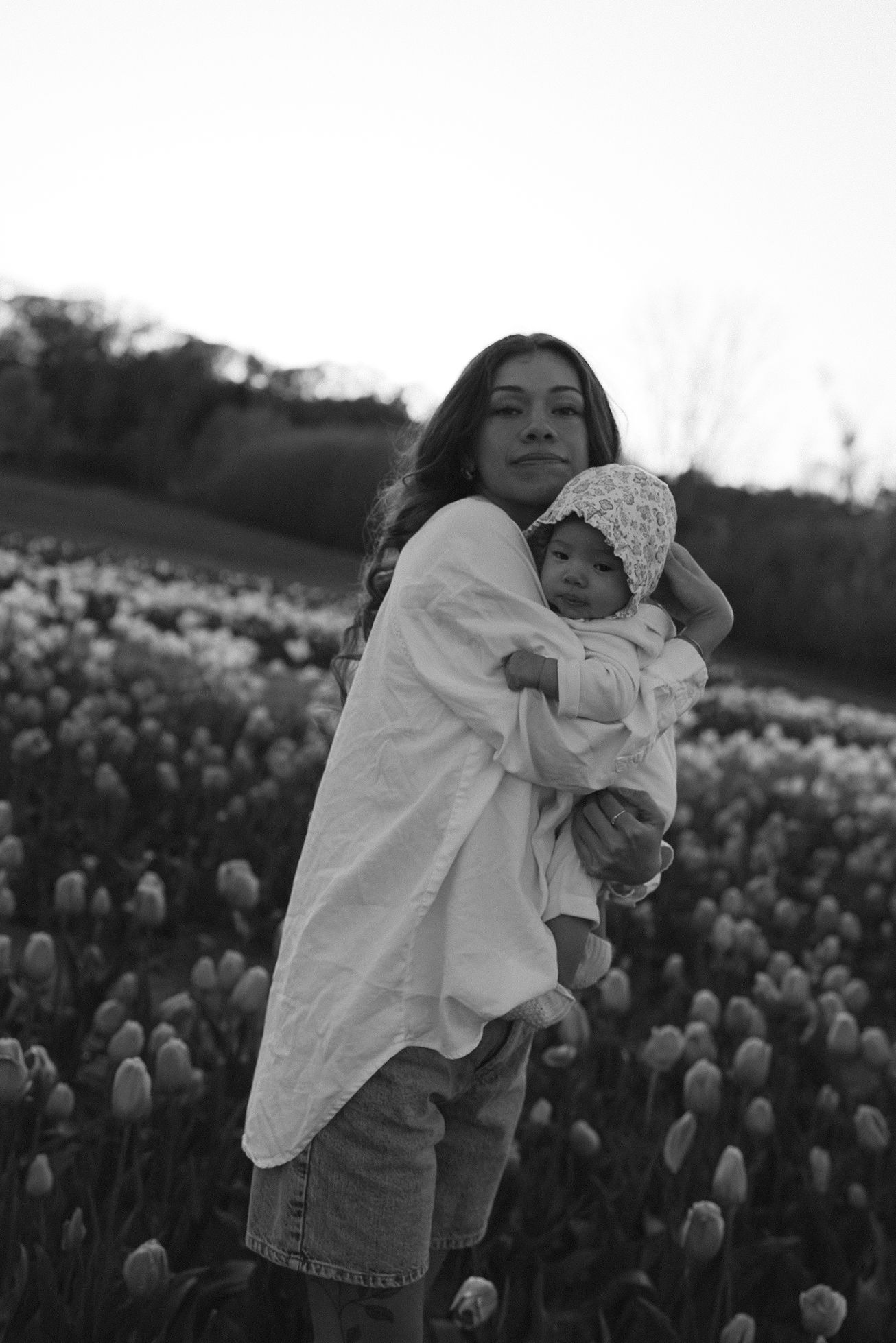 Black and white portraits in a tulip field at dusk.