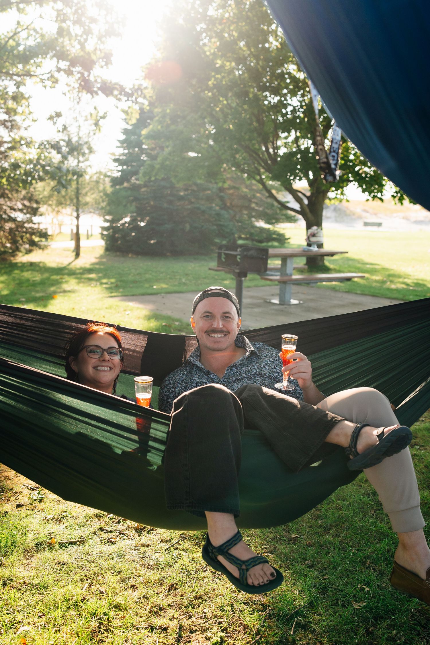 Friends relax in hammocks during casual outdoor celebration.