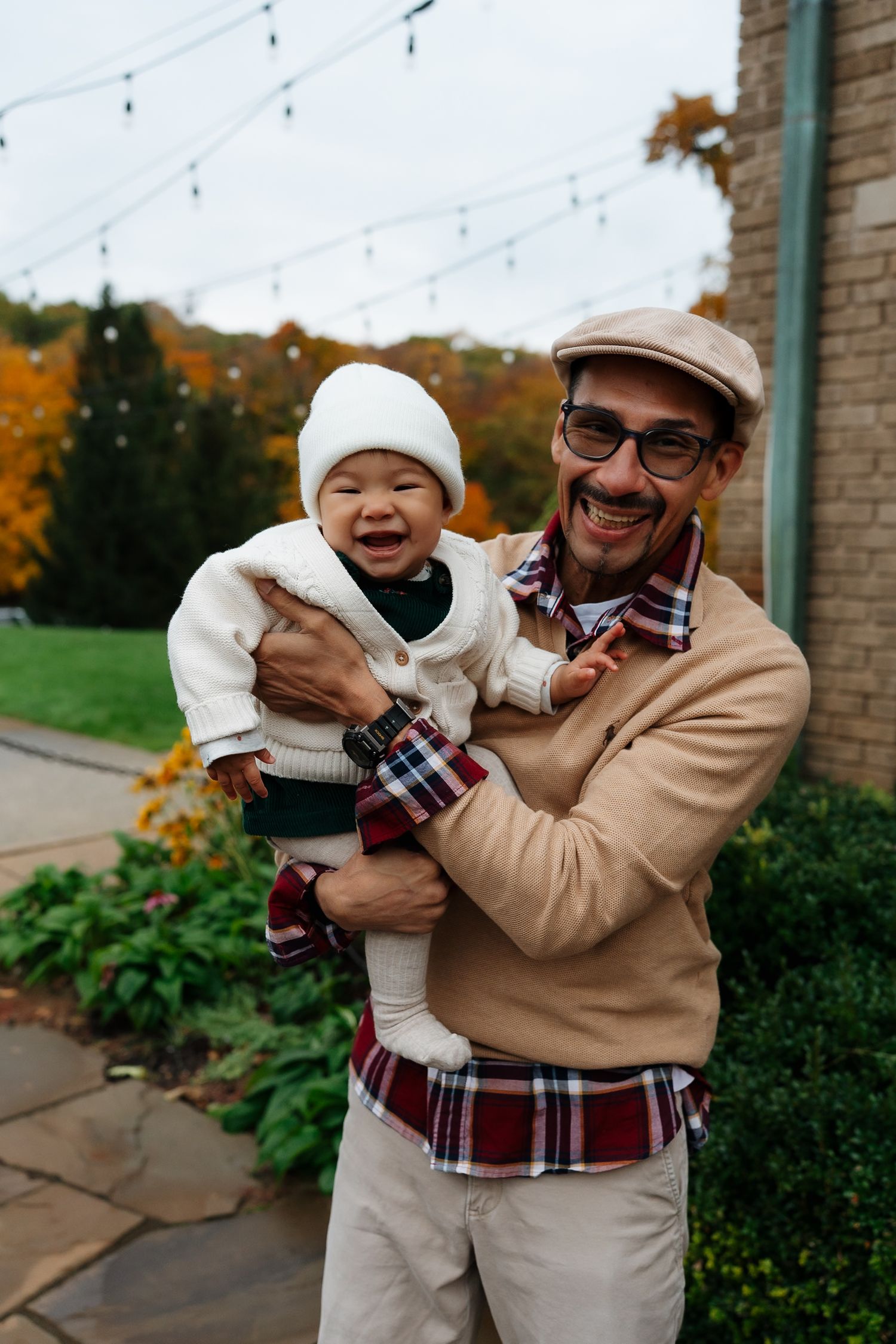 Autumn outdoor portrait with baby in white sweater and knit cap.