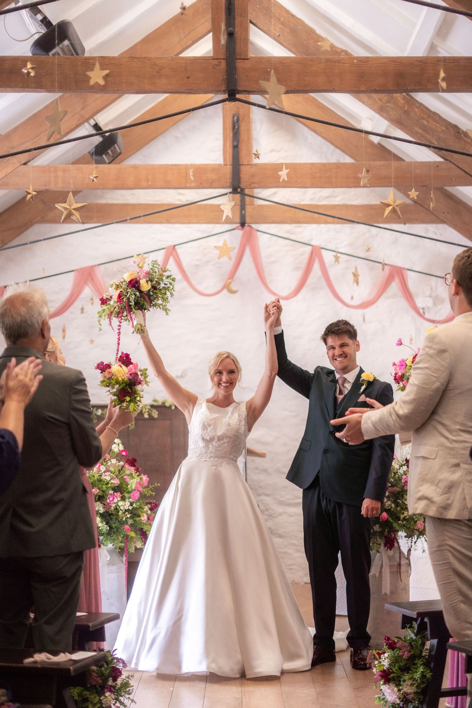 Bride and groom walking back down the isle after getting married at Trerice National Trust