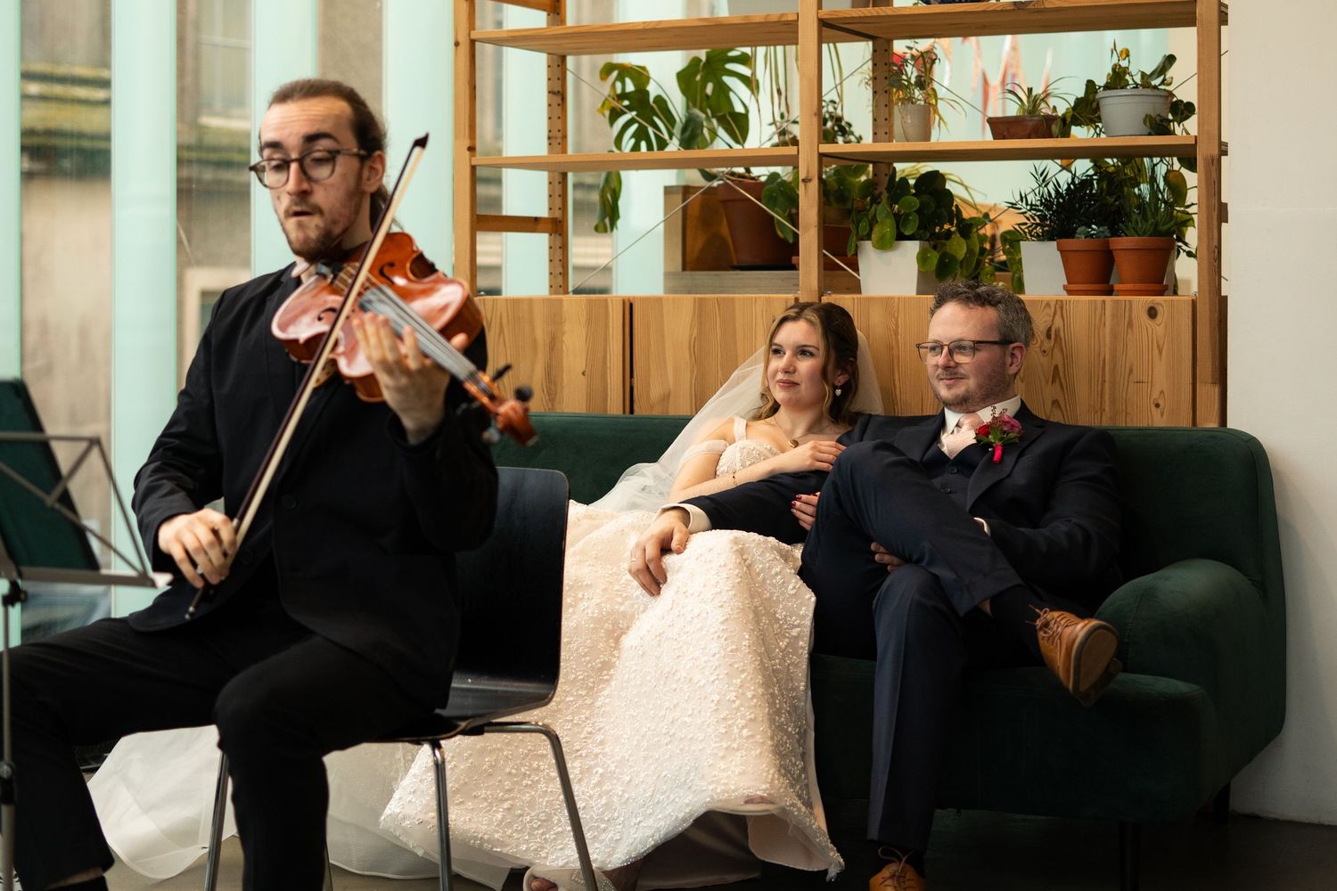 Bride and groom watching a string quartet at Newlyn Art Gallery & The Exchange in Penzance, Cornwall