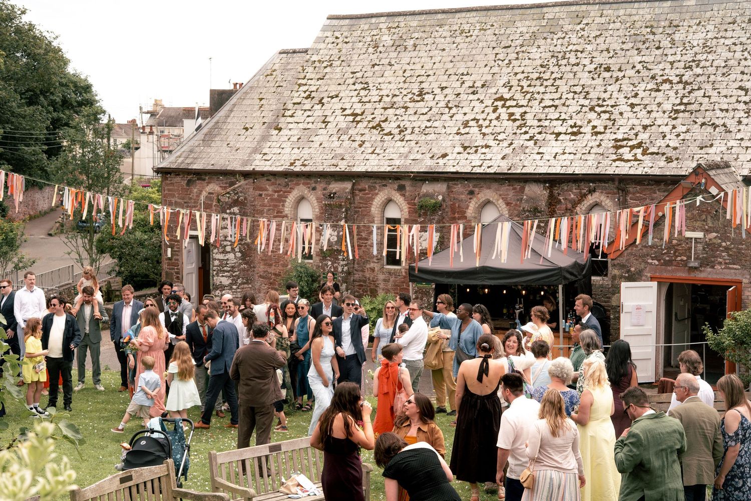 Wedding guests in the garden of the village hall