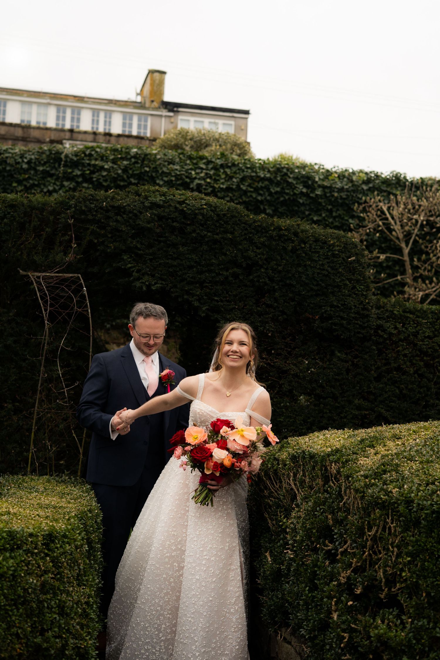 Relaxed, candid photo of bride and groom after their wedding ceremony in Penzance, Cornwall