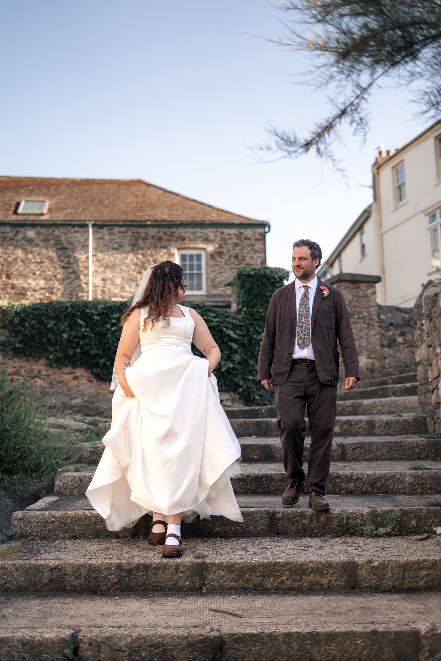 Bride and groom walking towards the beach for some wedding portraits