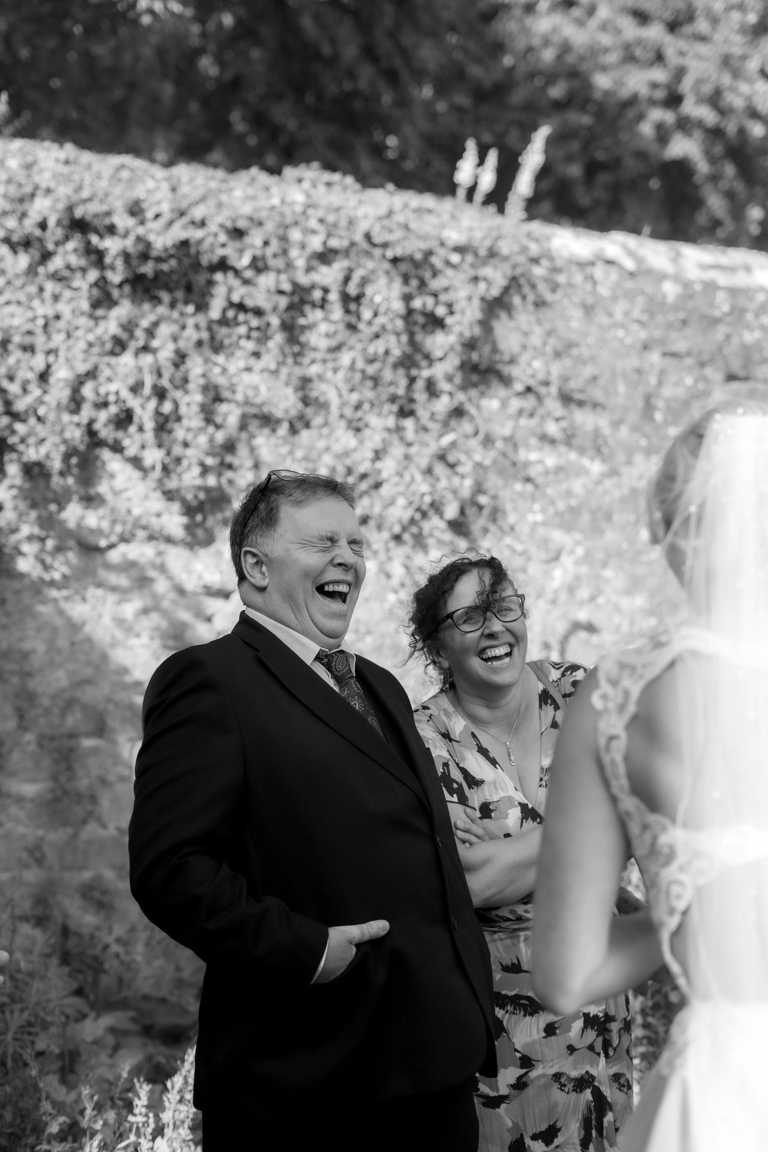 Candid photo of wedding guest laughing at Trerice National Trust