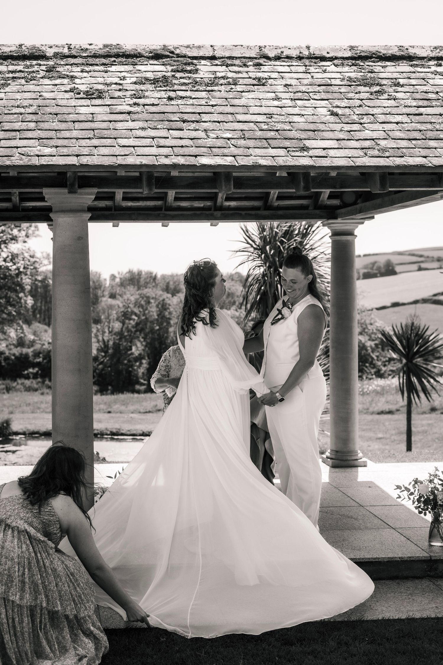 Two brides holding hands at the alter