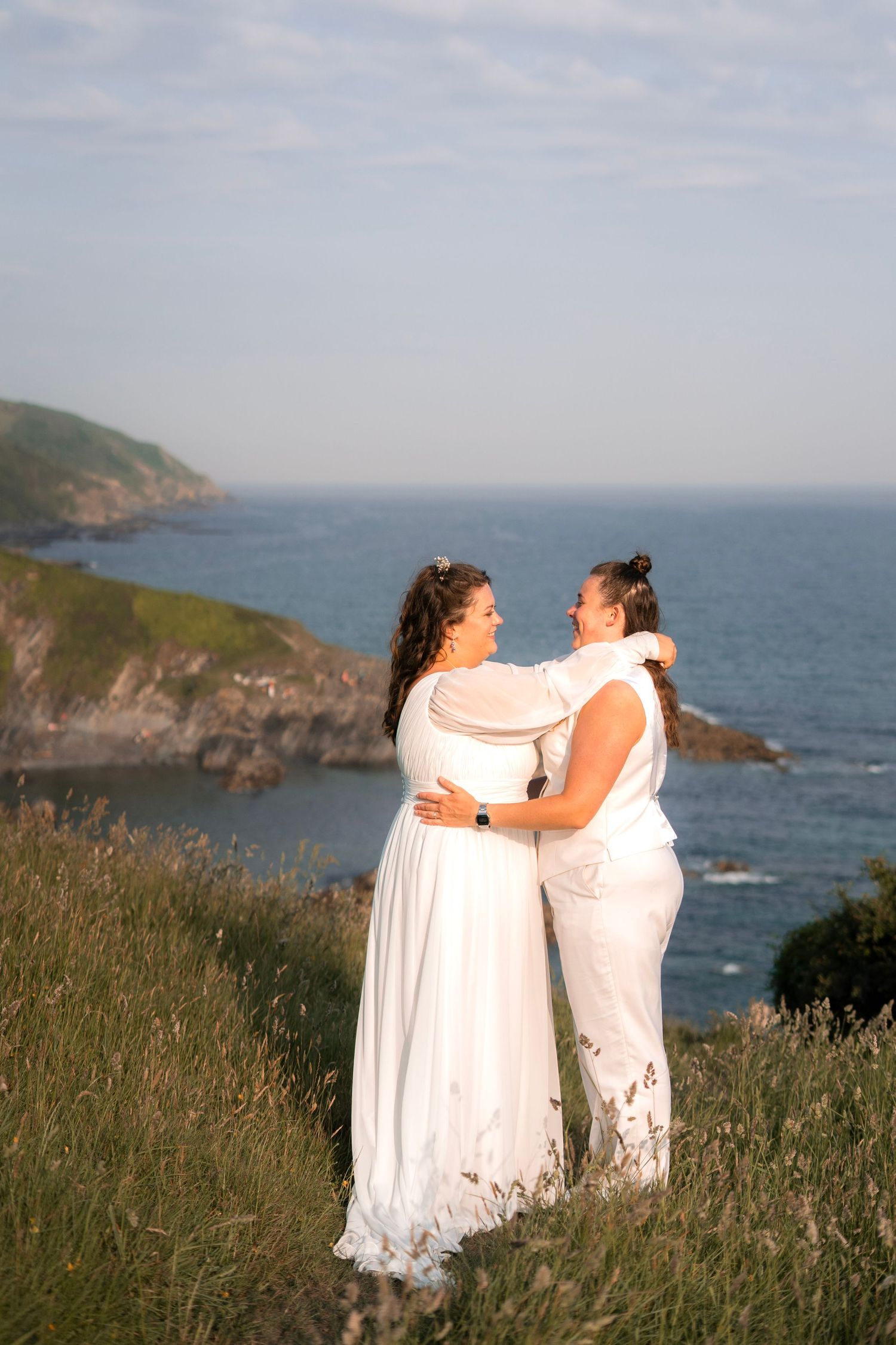 Two brides celebrating their wedding on the shore of Lantic Bay in Cornwall