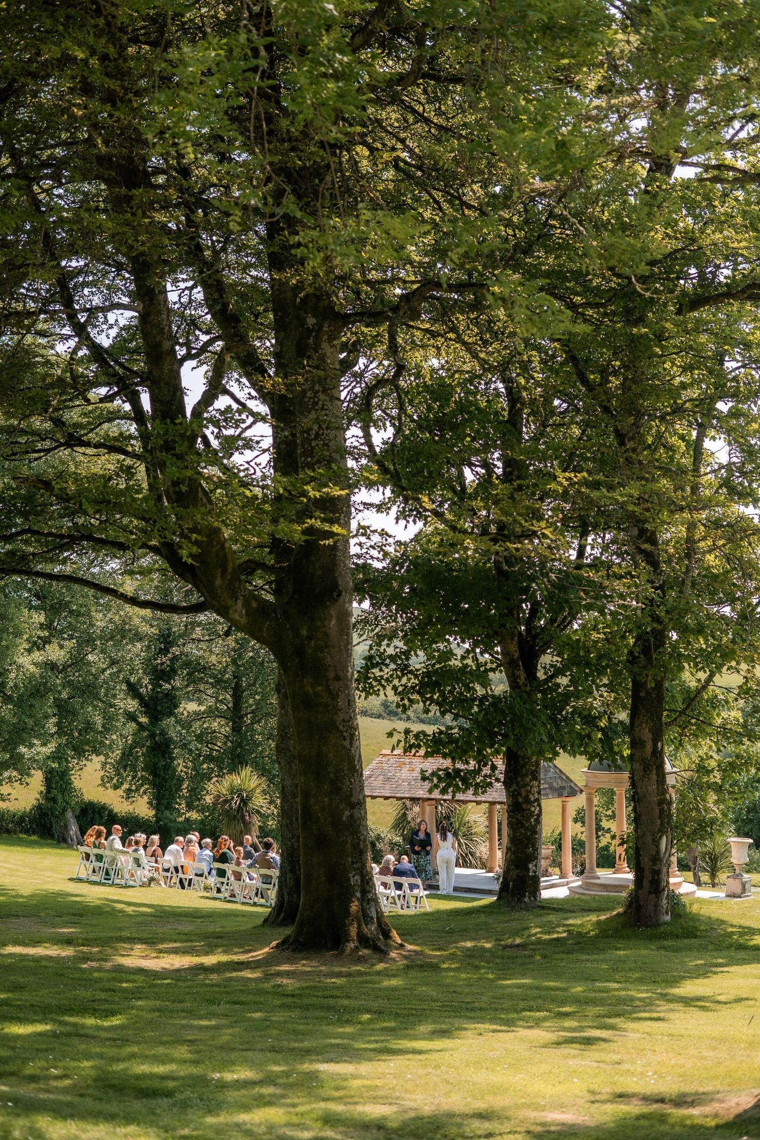 Guests gathering during an outdoor ceremony at Tredudwell Manor