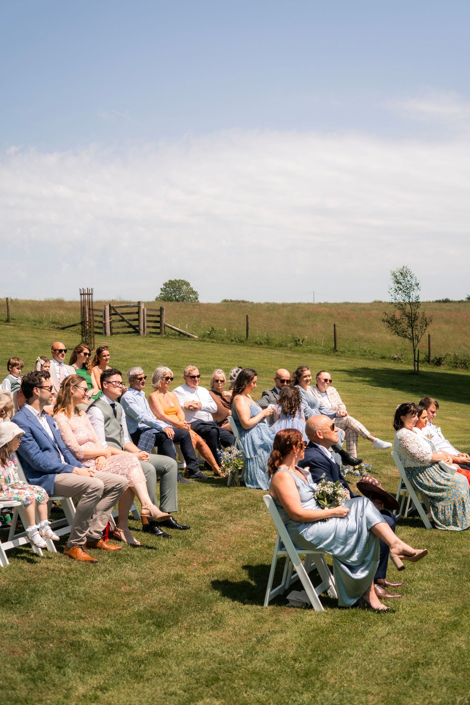 Wedding guests seated outside at Tredudwell Manor