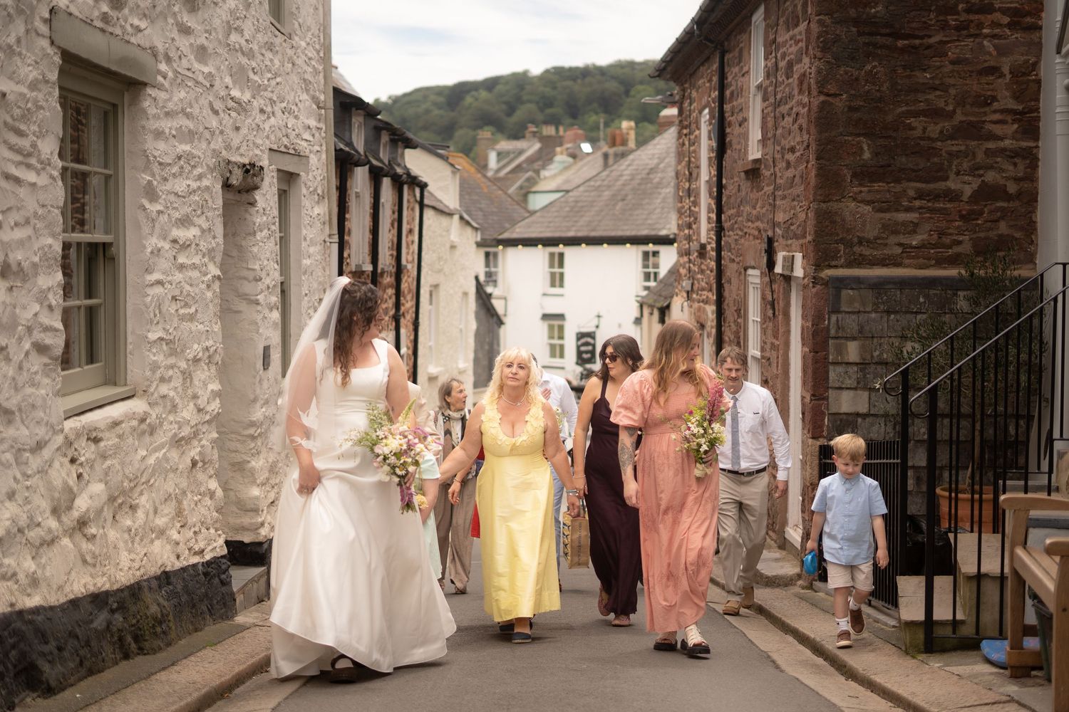 Bridal party walking through the Kingsand village towards Maker with Rame Community Hall