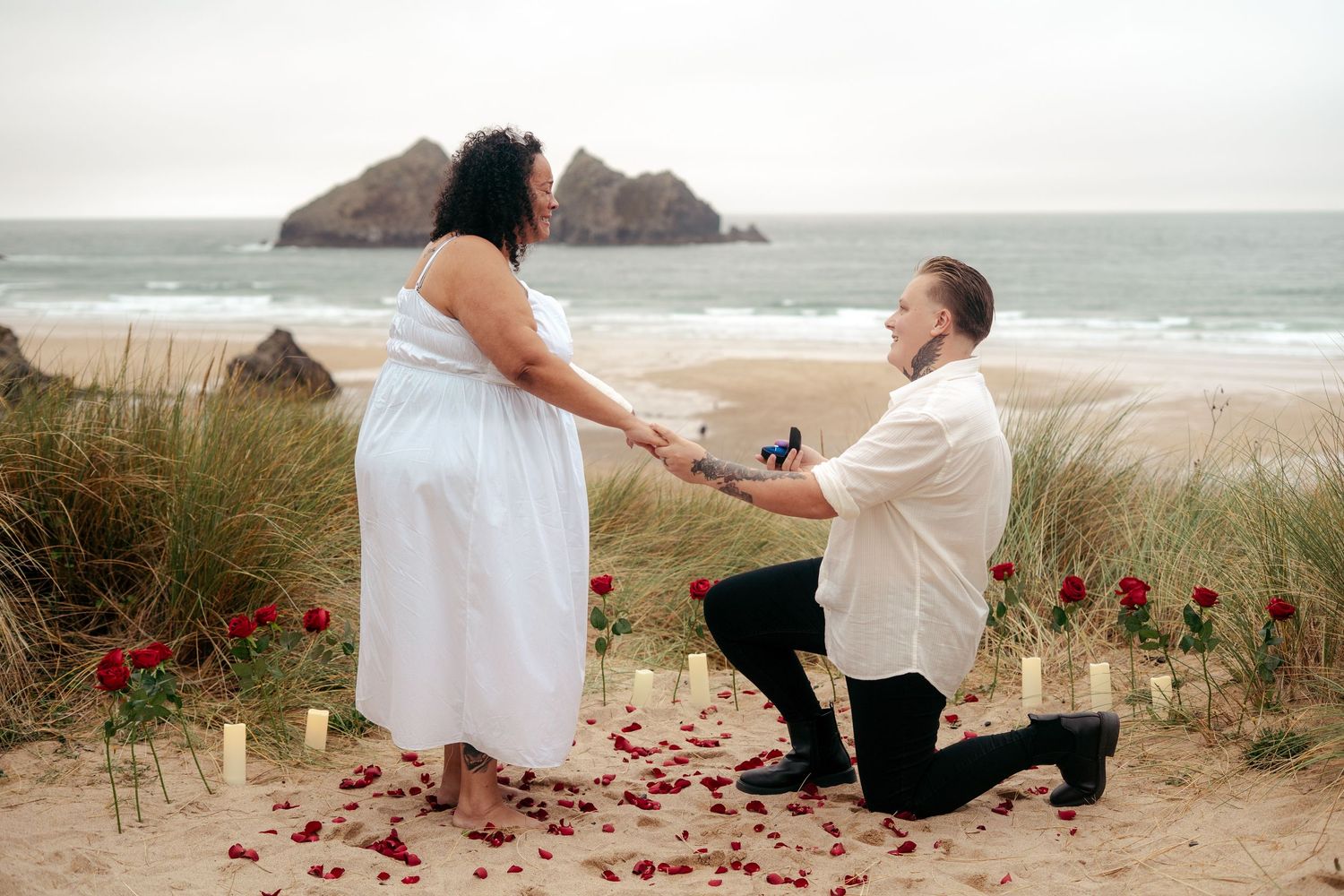Lesbian proposal on the beach in Cornwall, with the view of Holywell Bay in the background